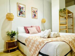 a bedroom with two beds with pillows on it at Dorado Cabanyal - Luxury Beachside Charm in Valencia +18 photos