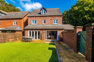 a brick house with a lawn in front of it at Grange House in Chester