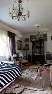 a living room with a chandelier and a bed at Vikendica Nada in Ljubovija