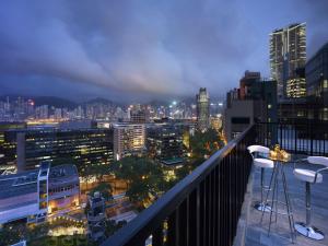 a view of a city at night from a balcony at Popway Hotel in Hong Kong