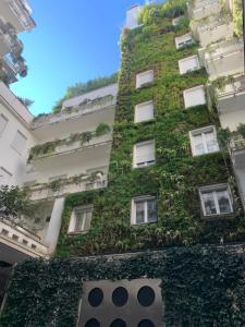 a building with green ivy on it at Fifty Eight Milan Duomo Two Bedrooms in Milan