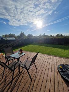 a patio with a table and chairs on a wooden deck at Entire House for a company of Friends in Kaunas