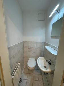 a bathroom with a toilet and a sink at Alex Apartments 3 in Solingen