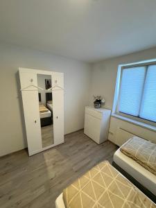 a bedroom with a bed and a mirror in it at Alex Apartments 3 in Solingen +4 photos