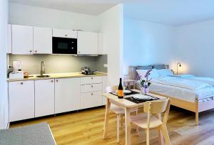 a kitchen and a bedroom with a bed and a table at Borgo Terra village in Fagagna