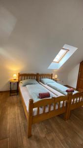 a bedroom with a large wooden bed with a skylight at Penzion Panská in České Budějovice