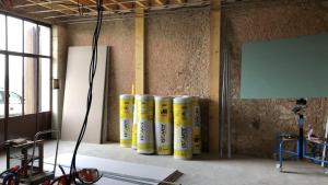 a group of yellow cylinders are lined up in a room at Loft de Dimeray in Trôo