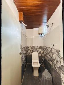 a bathroom with a toilet in a room at Wildwings hotel in Hyderabad