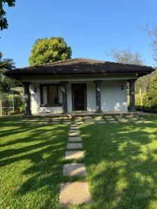 a house with a pathway in the grass at Robyns Nest Self Catering Cottage No4 in Gillitts-Emberton