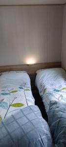 two beds sitting next to each other in a room at Bird's Bay cresswell towers in Cresswell +9 photos