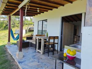 a kitchen and dining area of a house with a table and chairs at Villa Namaste - Cabaña Excélsior in Curití
