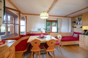 una cucina con tavolo, sedie e un divano di Idyllische Zirbenholz Alpin Huette a Turracher Hohe