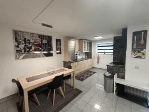a kitchen with a table and a dining room at Wunderschöne Wohnung mit Kamin in Starzach