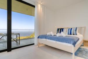 a bedroom with a bed with a view of the ocean at Mar Yam Sea by Atlantic Holiday in Arco de São Jorge