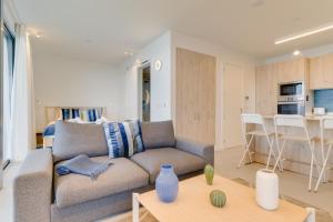 a living room with a couch and a table at Mar Yam Sea by Atlantic Holiday in Arco de São Jorge