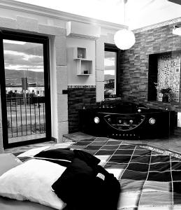 a bedroom with a large bed and a bath tub at Suite Dello Stretto in Messina
