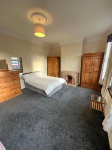 a bedroom with a large bed and a fireplace at City Escape in London +7 photos