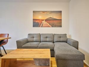 a living room with a couch and a table at Apartment Trendy Mountain Terrace Retreat by Interhome in Svoboda nad Úpou