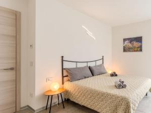 a bedroom with a bed in a white room at Apartment Arianna by Interhome in Arco