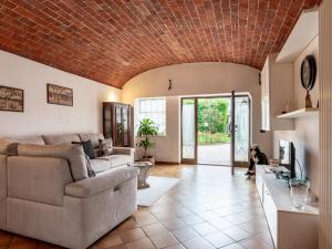 a living room with a brick ceiling at Apartment Tenuta Beatrice by Interhome in CastellʼAlfero
