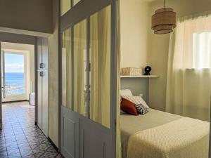 a bedroom with a bed and a view of the ocean at Apartment Mareviglia - Meereswunder by Interhome in Imperia