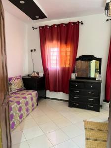 a living room with a couch and a red curtain at Modern Moroccan apartment near the beach in Safi in Safi