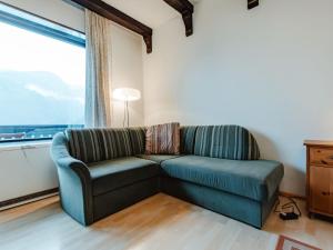 een bank in een woonkamer met een groot raam bij Apartment Landhaus St- Georg-7 by Interhome in Bad Gastein +27 foto's