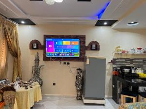 a living room with a television on the wall at Modern Moroccan apartment near the beach in Safi in Safi