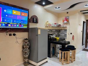a kitchen with a bar with a tv on the wall at Modern Moroccan apartment near the beach in Safi in Safi