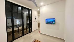 a television hanging on a wall in a room at Bukawa Residences Balangan in Jimbaran