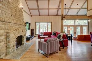 a living room with a red couch and a fireplace at View and access to Lake Orford - Spa - Australe in Austin