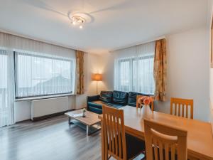 een woonkamer en eetkamer met een tafel en een bank bij Apartment Landhaus St- Georg-3 by Interhome in Bad Gastein