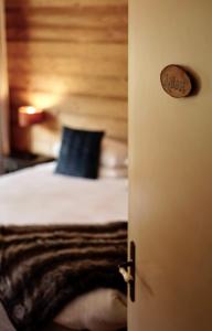 a bedroom door with a bed with a blue pillow at Chalet Narnia in Morzine