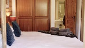 a bedroom with a bed with towels on it at Chalet Narnia in Morzine