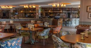 a restaurant with tables and chairs and a bar at The Bold Hotel; BW Signature Collection in Southport