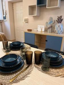 a table with blue plates and cups on it at Serena's turistic apartament in Parma