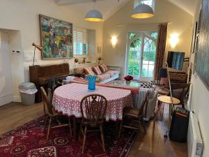 a living room with a table and a couch at Charming Old Schoolroom in Daventry