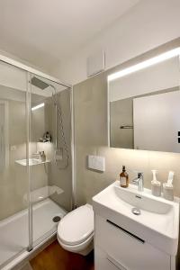 a bathroom with a toilet and a sink and a shower at Cocon by Stay Swiss - 1 bedroom apartments in old town in Porrentruy