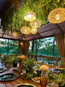 a wooden table with plants and lights on a deck at Cape Cod Villa in Harwich