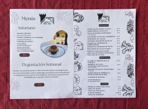 a menu for a restaurant on a table at Hotel Castillo Valdés Salas in Salas +20 photos
