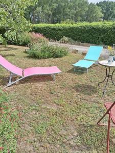 two chairs and a table and a table and a chair at Virevent in Carcassonne