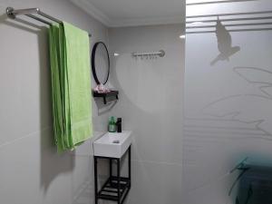 a bathroom with a sink and a shower with a mirror at Thula Thula Bali Villas in Kerobokan