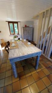 a table in a living room with a blue table sidx sidx sidx at Fermette Ardennaise typique in Wanlin +23 photos