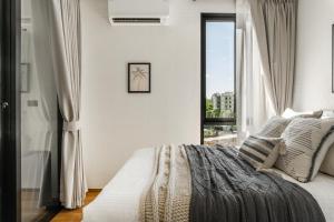 Ένα ή περισσότερα κρεβάτια σε δωμάτιο στο Title Halo Memories Naiyang Pool Gym Sauna +53 φωτογραφίες