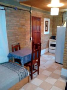 a kitchen with a table and a table and a refrigerator at DEPARTAMENtO LOFT in Posadas