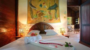 a bedroom with a bed with towels on it at Luxury villa in Nosy Be with pool in Nosy Be