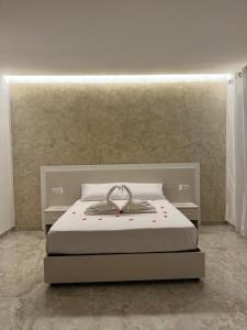 a bedroom with a bed and two night stands at La Chic Maison in Corbara