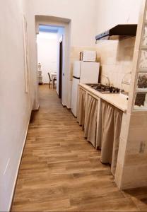 a kitchen with a counter top and a refrigerator at Casa Principe Taranto "Intero appartamento INDIPENDENTE" in Taranto +42 photos
