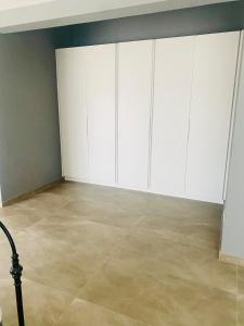 a room with white cabinets and a tile floor at 114 Zinnia in Midrand