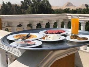 a tray with plates of food on a table at Sakkara pyramid inn hotel in Cairo